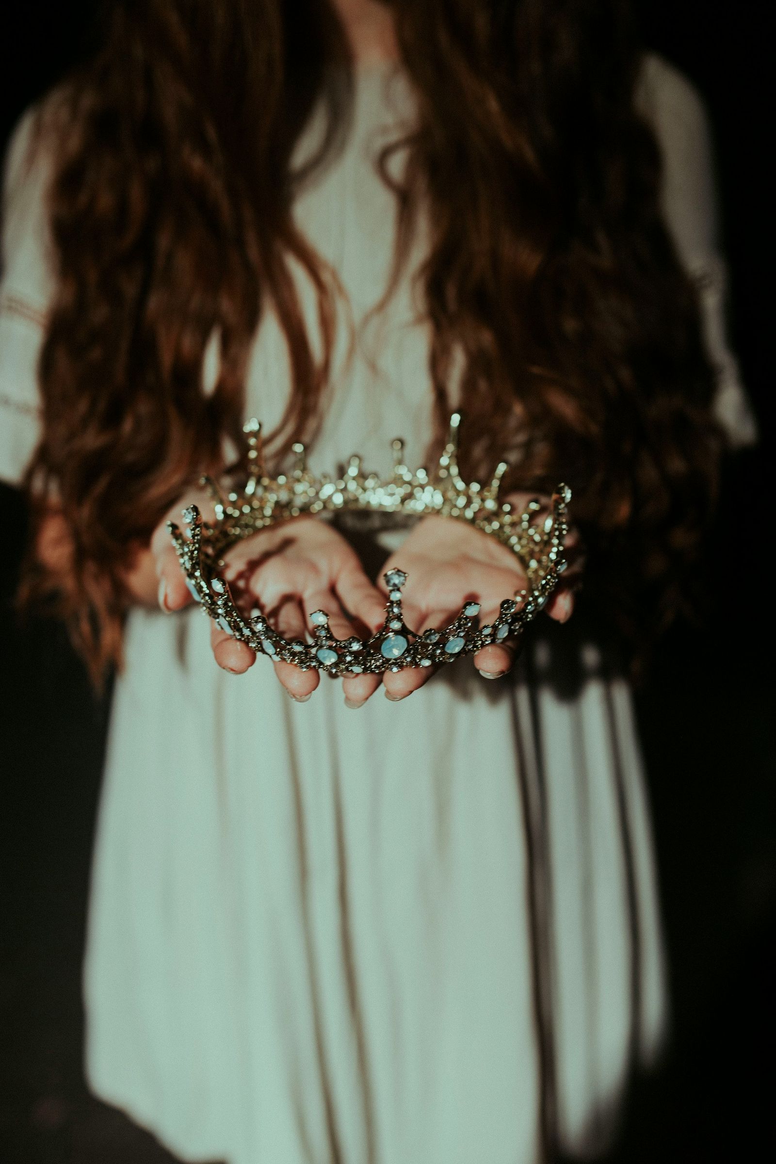 Person holding a crown